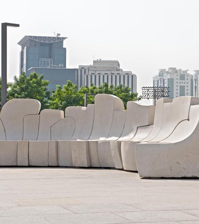 Bench by Saloua Raouda Choucair against a city background