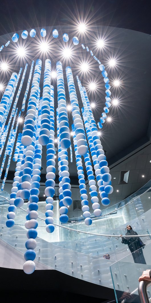 Chandelier consisting of a collection of sports balls
