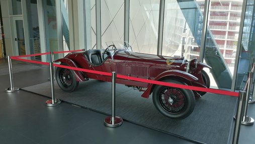 Red Scuderia Ferrari 1933 displayed in a museum space