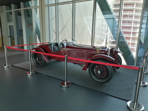 Red Scuderia Ferrari 1933 displayed in a museum space
