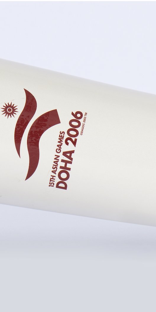 A horizontal white torch with a burgundy leather strap and the logo of Doha 2006 Asian Games