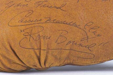 A signature on caramel leather says 'Cassius Marcellus Clay, Rome Bound'.