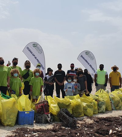Volunteers cleaning the beach at Sealine