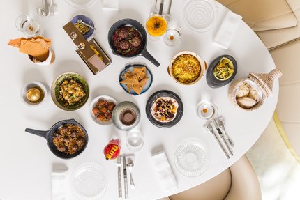 صورة علوية تظهر طاولة مطعم تضم عدداً من أطباق الطعام التقليدية التي يقدمها