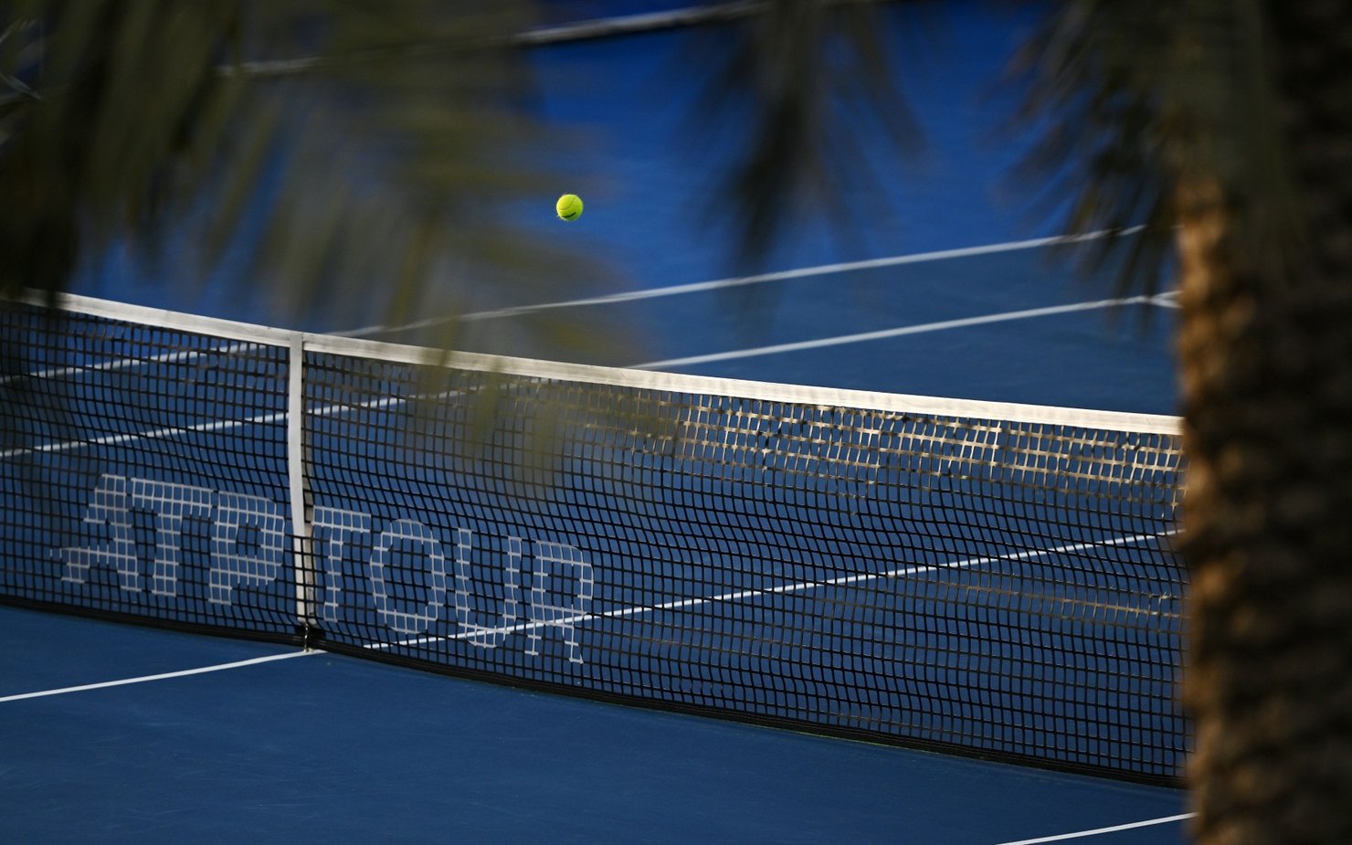 tennis court with a yellow ball