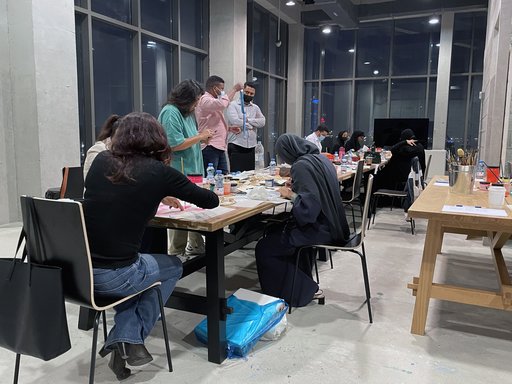 Participants in the workshop “Screen-printing Tote bags” at Fire Station working on their desks in the Education Studio.